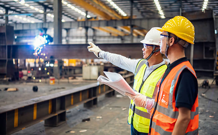 Two engineers providing EHS strategy and management in factory 