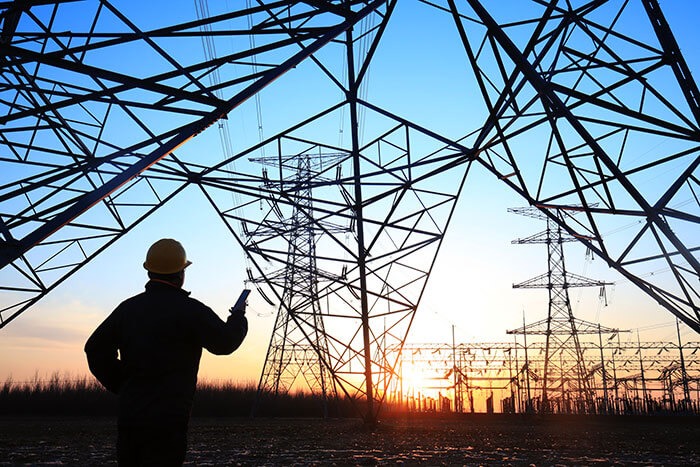 Man with phone providing on-site energy consulting services.