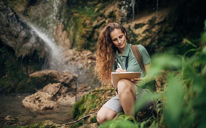 Scientist providing natural resource consulting in forestry setting