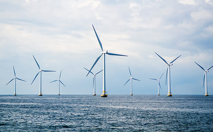 Nine wind turbines at sea used for renewable energy consulting 