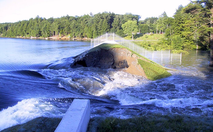 Water flowing through open embankment dam