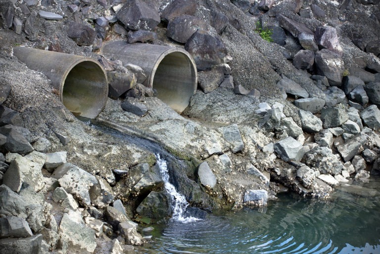 Pipes releasing stormwater into body of water