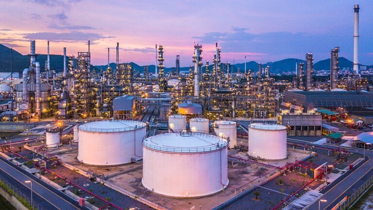 Image of industrial site with large white tanks.