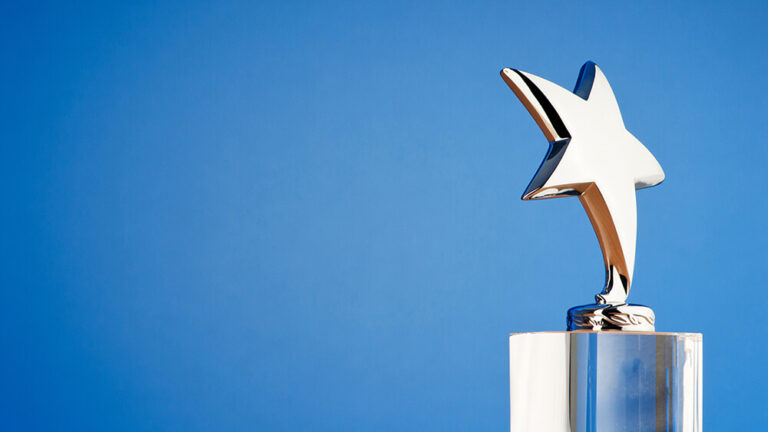 Silver star award on blue background