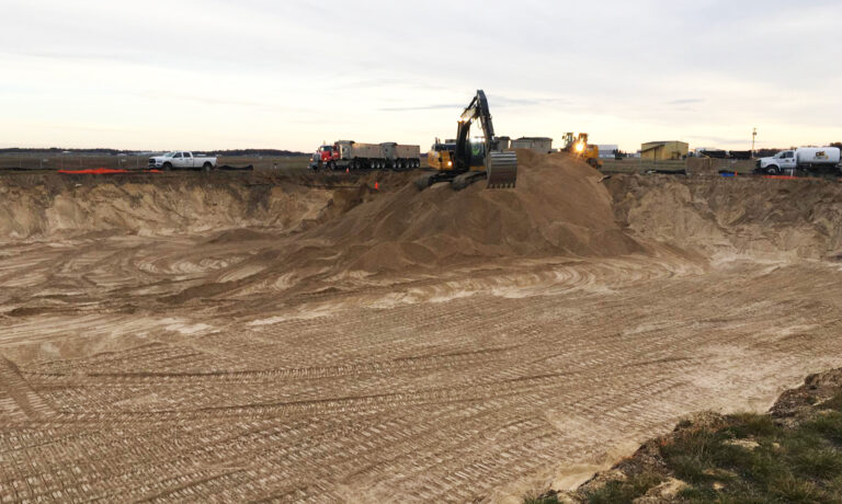 Construction site with excavation equipment in the background.