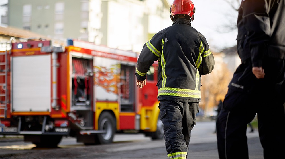 Firefighters walking toward a fire truck