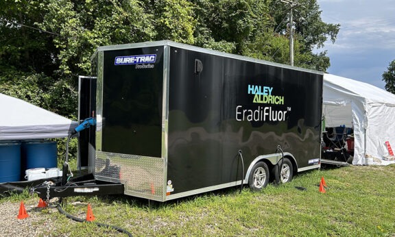 EradiFluor trailer on grassy, forested site