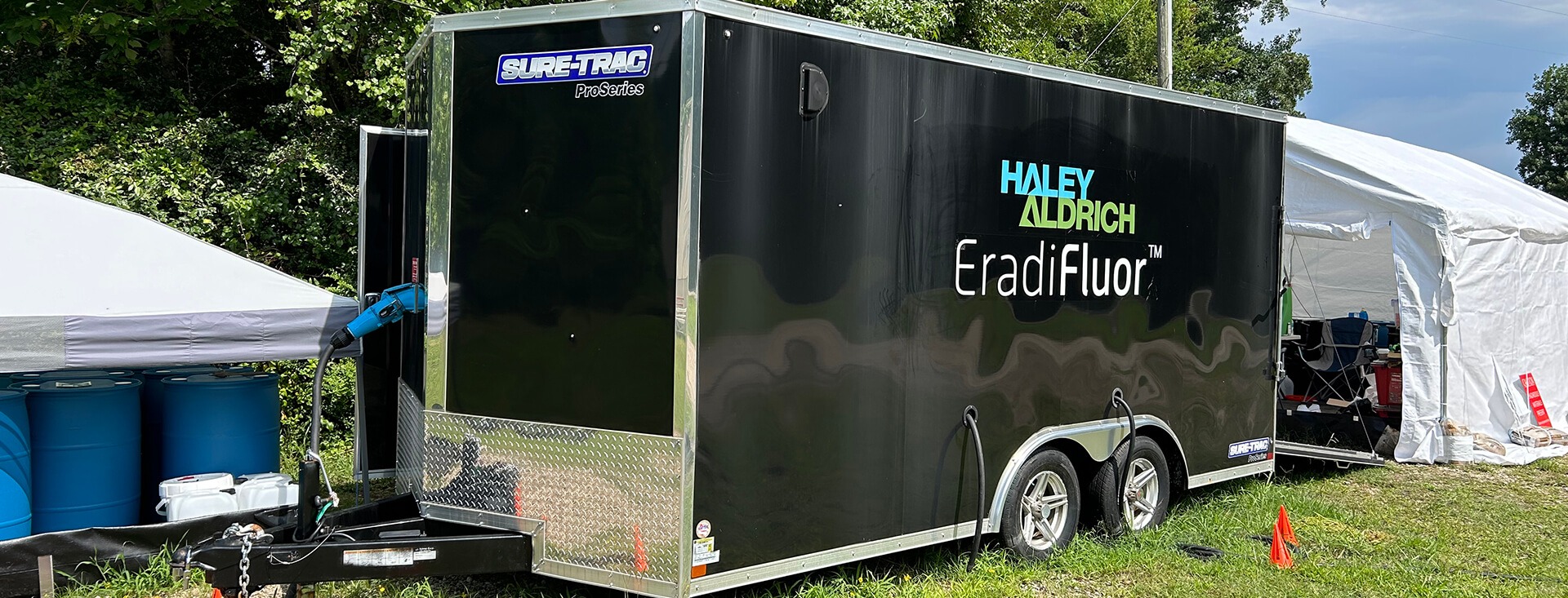 EradiFluor trailer on grassy, forested site